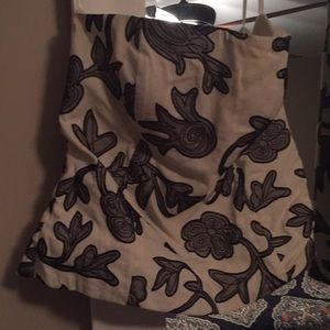 Two-piece skirt and strapless top formal outfit.